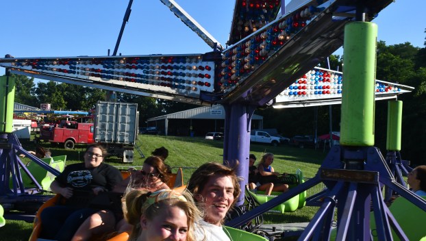 Cassada Herman (L) and Jack James (R) enjoy a spin onboard the Space Sled at the Clark County Fair.